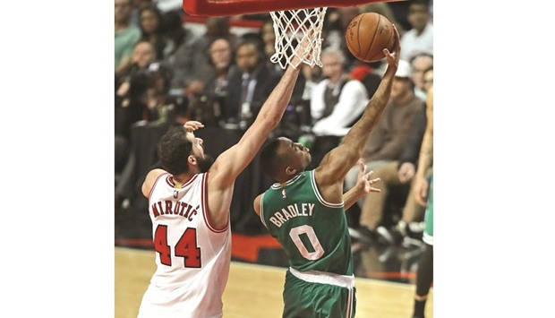 Avery Bradley (right) of the Boston Celtics goes for the basket past Nikola Mirotic of the Chicago Bulls during Game Six of the Eastern Conference quarter-finals during the 2017 NBA Playoffs in Chicago on Friday. (AFP)