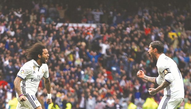 Real Madridu2019s Marcelo (L) celebrates after scoring yesterday.