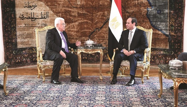 A handout picture shows Egyptian President Abdel Fattah al-Sisi meeting with Palestinian leader Mahmoud Abbas in the capital Cairo yesterday.