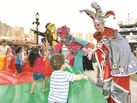Children being entertained by fairy tale characters.