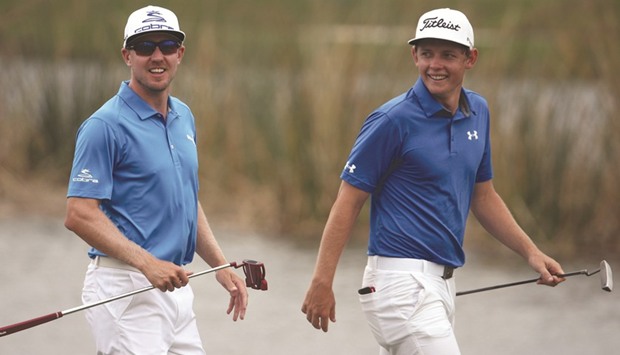 Cameron Smith of Australia and Jonas Blixt of Sweden walk up the 9th fairway during the second round of the Zurich Classic at TPC Louisiana.