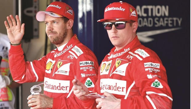 Vettel and teammate Kimi Raikkonen after the qualifying session. (AFP)