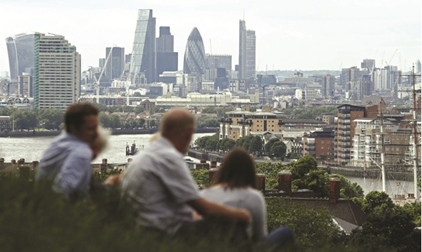 This file photo taken on June 26, 2016 shows the skyline of London on the horizon as people relax in Greenwich park in southeast London. Britain took a significant step towards exposing dirty money in the London property market this week, passing a law allowing the seizure of homes from foreigners who cannot explain how they paid for them.