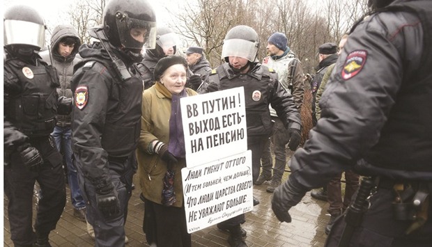 Police officers detain an activist during the protest in Saint Petersburg.