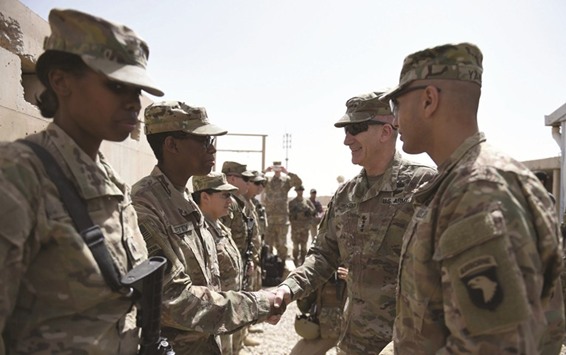 The US commander in Afghanistan John Nicholson (2R) shakes hand with US soldiers ahead of a handover ceremony at Leatherneck Camp in Lashkar Gah in the Afghan province of Helmand yesterday.