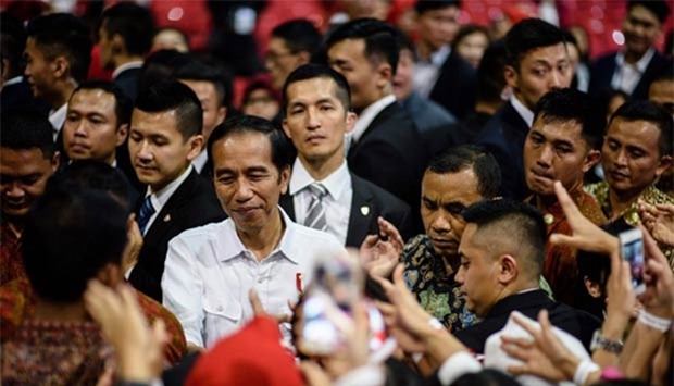 President Joko Widodo meets Indonesian workers in Hong Kong on Sunday.