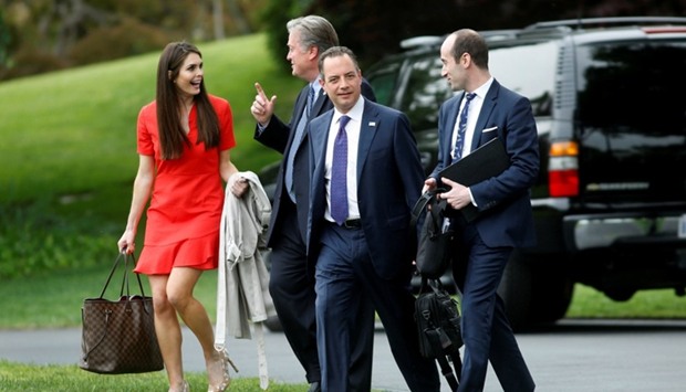 White House Director of Strategic Communications Hope Hicks, Chief Strategist Steve Bannon, Chief of Staff Reince Priebus and Senior Advisor Stephen Miller follow US President Donald Trump (not seen) on the South Lawn of the White House in Washington, US, before his departure to Harrisburg, Pennsylvania.