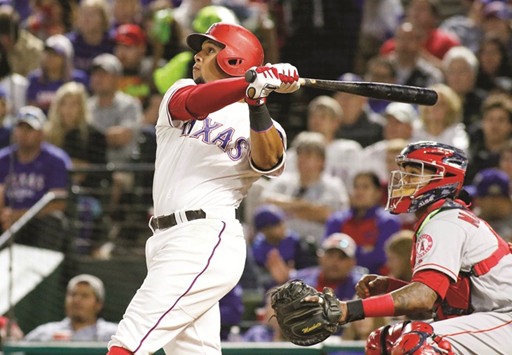 Texas Rangers center fielder Carlos Gomez (left) watches his home run to complete the cycle leave the ball park against the Los Angeles Angels in the seventh inning in Arlington, Texas, on Saturday. (USA TODAY Sports)