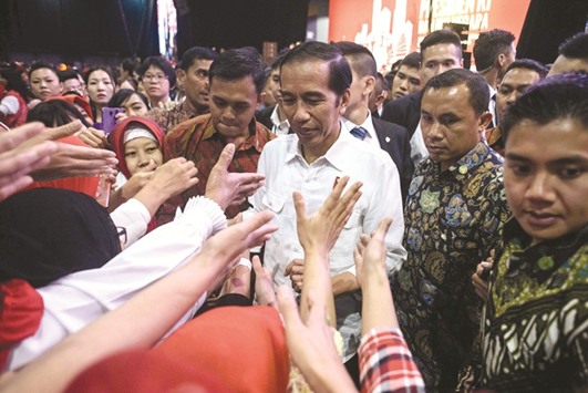Indonesian President Joko Widodo meets workers from Indonesia at an event during his visit to Hong Kong yesterday.