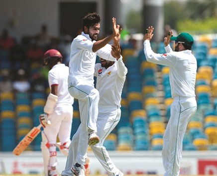 Mohamed Amir of Pakistan celebrates the wicket of Kraigg Brathwaite of West Indies on Day One of the second Test in Bridgetown, Barbados, yesterday. (AFP)