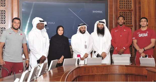Talal Mansour (second from left) with Qatar Athletics Federation officials and young Qatari athletes at a press conference yesterday.