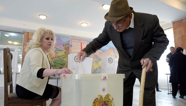 A man casts his ballot at a polling station in Yerevan