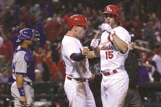 St. Louis Cardinals left fielder Randal Grichuk (No 15) is congratulated by right fielder Stephen Piscotty after hitting a two run home run off Chicago Cubs relief pitcher Pedro Strop (not pictured) during the eighth inning of opening night at Busch Stadium. The Cardinals won 4-3. PICTURE: USA TODAY Sports