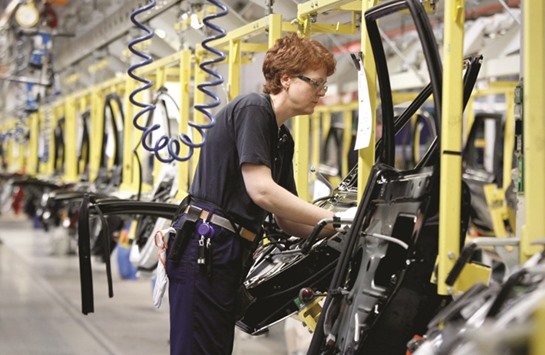 A worker assembles car doors at the main Volvo automobile manufacturing factory in Gothenburg. In the eurozone, IHS Markitu2019s final manufacturing Purchasing Managersu2019 Index rose to its highly in nearly six-year high of 56.2 in March, far above the 50 mark that separates growth from contraction.