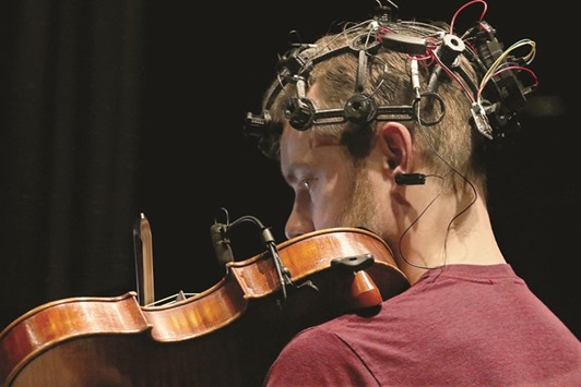 WIRED: John Richards with the JACK Quartet, visiting from NYC, is wired up with an EEG cap while playing music during a rehearsal at the University of Washingtonu2019s Meany Hall.
