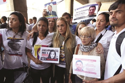 Lilian Tintori (C), wife of jailed opposition leader Leopoldo Lopez with relatives of imprisoned dissidents as they attend a gathering outside of the offices of Venezuelau2019s ombudsman in Caracas yesterday.