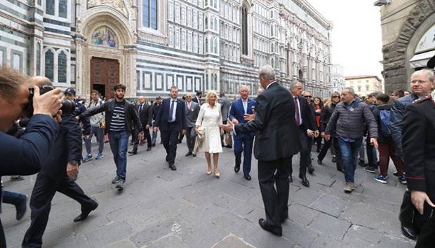 Prince Charles, Prince of Wales, and the Duchess of Cornwall, Camilla, walk along the cathedral Santa Maria del Fiore in Florence, Italy, yesterday.