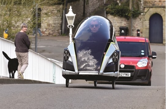 Grant Sinclair, nephew of Sir Clive Sinclair, who developed an electric tricycle in the 1980s, rides his invention, the Iris E-Trike electric tricycle, in Chepstow, Wales.