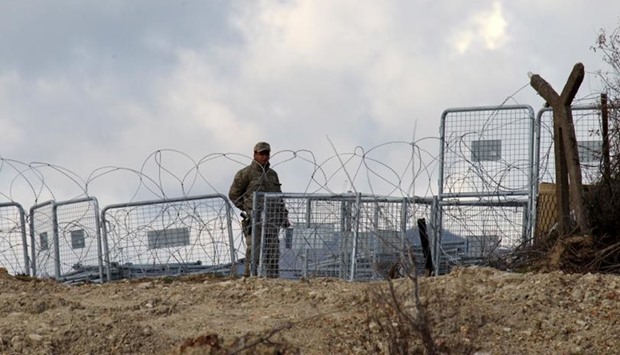 A Turkish soldier standing guard is seen from the Syrian town of Khirbet Al-Joz at the Turkish-Syrian border, in Latakia countryside, where internally displaced Syrian people are waiting to get permission to cross into Turkey, Feb. 7, 2016. Photo: REUTERS