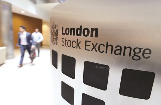 Visitors pass a sign inside the main atrium of the LSE headquarters in London. The FTSE 100 closed up 0.5% at 7,321.82 points yesterday.