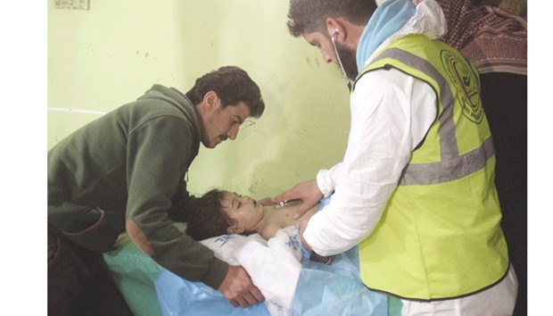 An unconscious Syrian child receives treatment at a hospital in Khan Sheikhun, a rebel-held town in the northwestern Syrian Idlib province, following a suspected toxic gas attack yesterday.