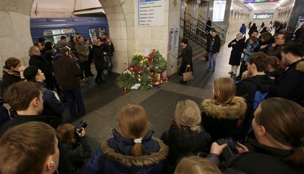 People mourn next to memorial site for victims of blast in St. Petersburg metro