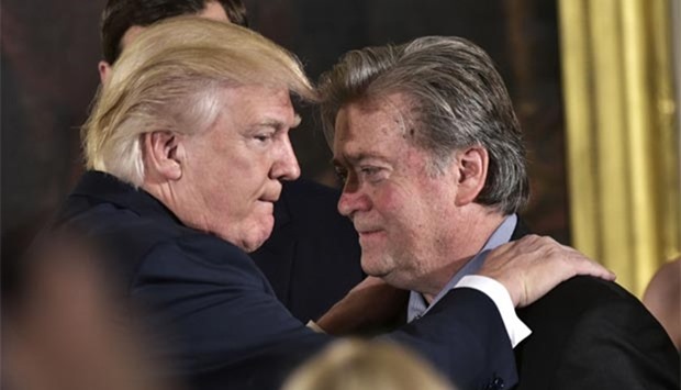 Steve Bannon, seen with President Donald Trump, has lost his seat on the powerful National Security Council.