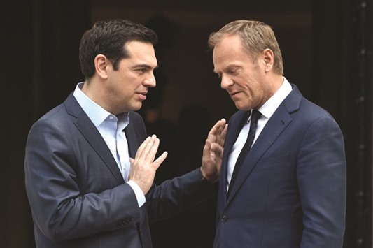 Greek Prime Minister Alexis Tsipras (left) gestures as he speaks with European Councilu2019s President Donald Tusk after their meeting in Athens yesterday. Tsipras said he would ask for an EU leaders summit if there was no deal this week and accused some creditors of being obstinate.