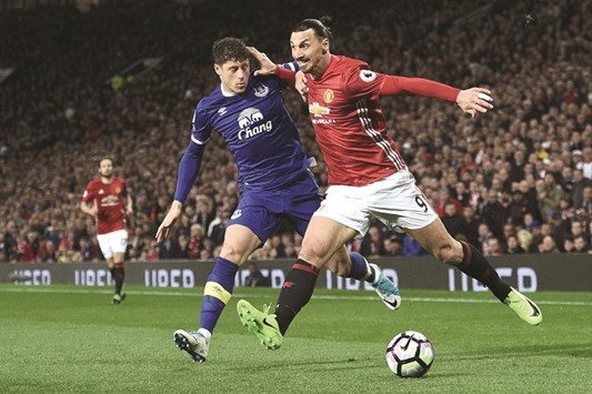 Manchester Unitedu2019s Swedish striker Zlatan Ibrahimovic (R) vies with Evertonu2019s English midfielder Ross Barkley during their English Premier League match at Old Trafford in Manchester, north west England. (AFP)