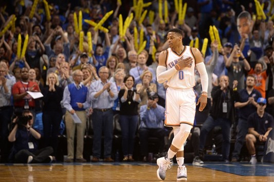 Oklahoma City Thunder guard Russell Westbrook (0) reacts as it announced that he has tied the season triple double record in action against the Milwaukee Bucks.