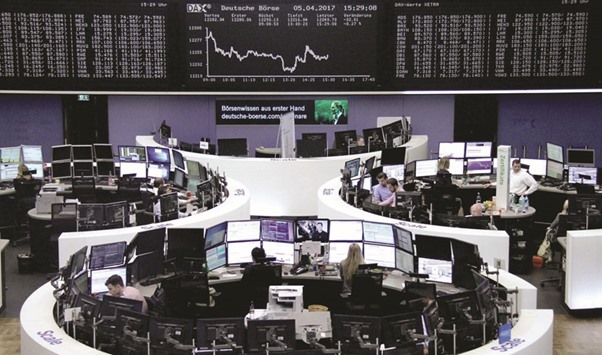 Traders at the Frankfurt Stock Exchange. The DAX 30 yesterday lost 0.5% to 12,217.54 yesterday.