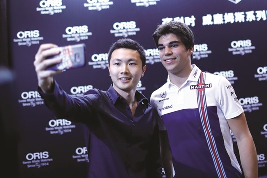Williams driver Lance Stroll (right) poses for a selfie during a promotional event in Shanghai yesterday. (Reuters)