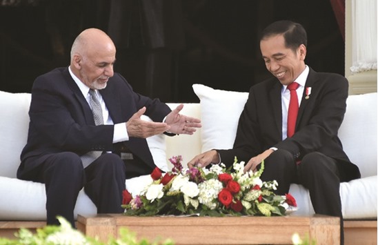 Indonesian President Joko Widodo and Afghan President Mohamed Ashraf Ghani chat during their meeting at presidential palace in Jakarta, yesterday.