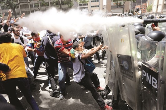 Demonstrators clash with security forces during an opposition rally in Caracas on Tuesday.