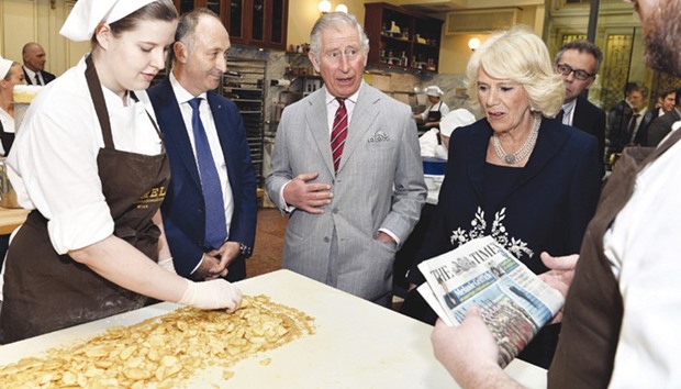 (Second left to right) CEO of the Vienna-based Do&Co catering company, Attila Dogudan, Prince Charles, Prince of Wales, and his wife Camilla, Duchess of Cornwall, visit the traditional Viennese coffee house Demel in Vienna, Austria, yesterday.