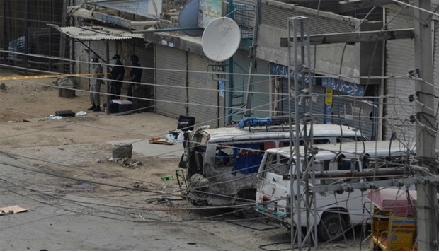 A Pakistani forensic team arrives at the scene of a suicide bomb attack on a census team in Lahore