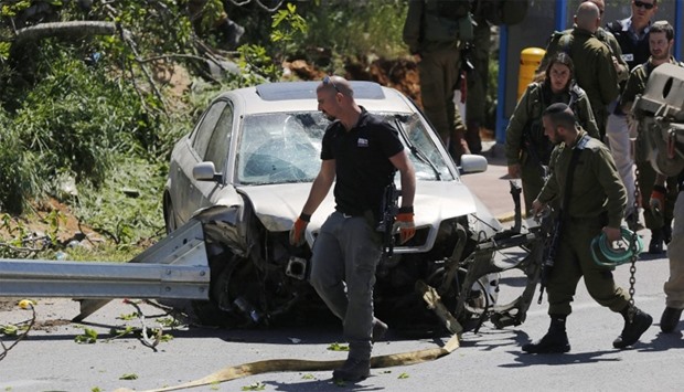 Israeli security forces gather at the site of a car ramming attack