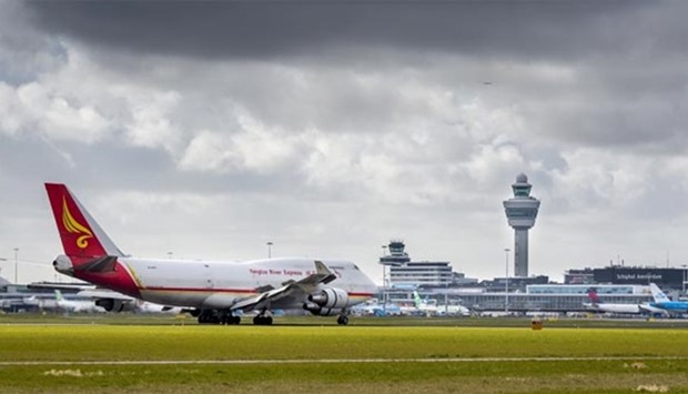A Yangtze River Express plane is pictured next to the control tower at Schiphol Airport in Amsterdam.