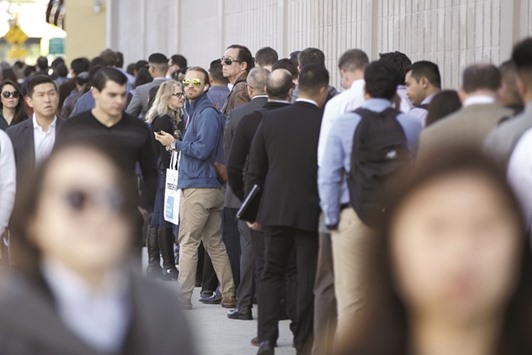 Job seekers wait in line during a job fair in Los Angeles. Initial claims for state unemployment benefits declined 25,000 to a seasonally adjusted 234,000 for the week ended April 1, the US Labor Department said yesterday.