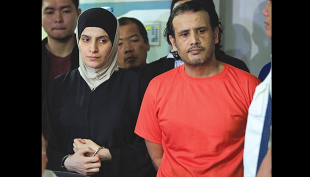Kuwaiti Husayn al-Dhafiri, right, and Syrian Rajaf Zina are presented to the media during a press conference at the National Bureau of Investigations (NBI) headquarters in Manila yesterday.