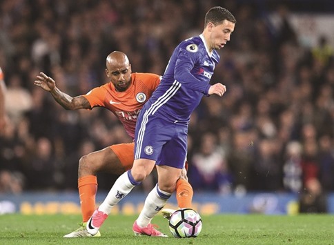 Manchester Cityu2019s Fabian Delph (left) challenges Chelseau2019s Eden Hazard during the English Premier League match at Stamford Bridge in London on Wednesday night. (AFP)
