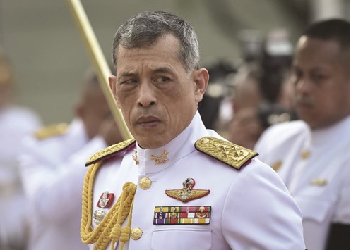 Thailandu2019s King Vajiralongkorn is seen paying respects to the monument of King Rama I after signing the military-backed constitution in Bangkok yesterday.
