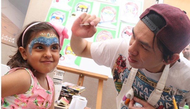 Face painting with Thai artist Sinchai Zonputh or 'Ooh', who is scheduled to conduct a workshop on paper mache next month. PICTURE: Jayan Orma.
