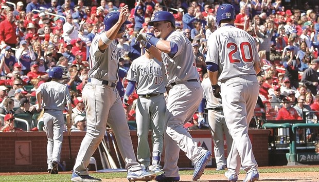 Chicago Cubs catcher Kyle Schwarber (centre) is congratulated by Jon Jay (left) after hitting a three-run home run against the St. Louis Cardinals at Busch Stadium in St. Louis, Missouri, on Thursday. (USA TODAY Sports)