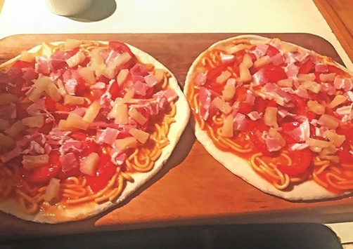 This photo released by New Zealand PM Bill English from his Facebook page shows pizzas English made topped with tinned spaghetti and pineapple for his family in Wellington.