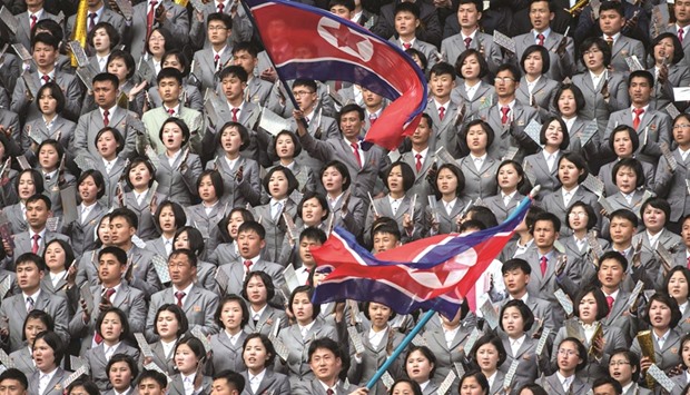 North Korea fans wave flags as they support their team against South Korea during their AFC Womenu2019s 2018 Asian Cup match at the Kim Il-Sung stadium in Pyongyang yesterday.