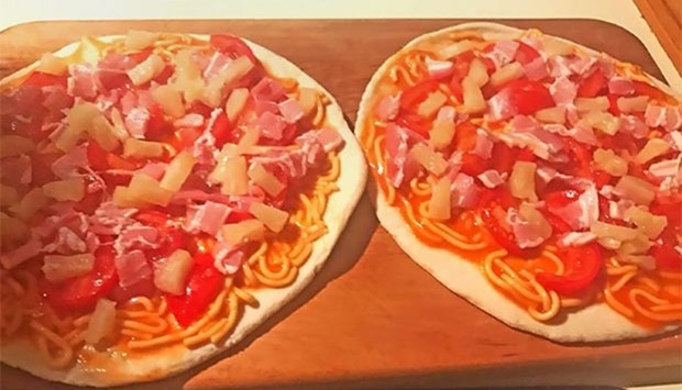 This undated photo released by New Zealand Prime Minister Bill English from his Facebook page on Friday shows pizzas that English made topped with tinned spaghetti and pineapple for his family in Wellington.