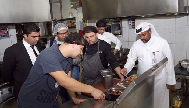 Doha Municipality officials inspect a food establishment