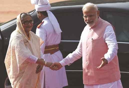 Indian Prime Minister Narendra Modi, right, shakes hands with Bangladesh Prime Minister Sheikh Hasina during a ceremonial reception at Presidential House in New Delhi yesterday.