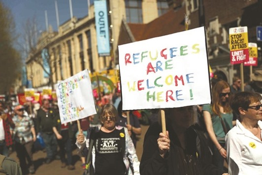 Demonstrators take part in a protest following a brutal attack on a teenage asylum seeker.